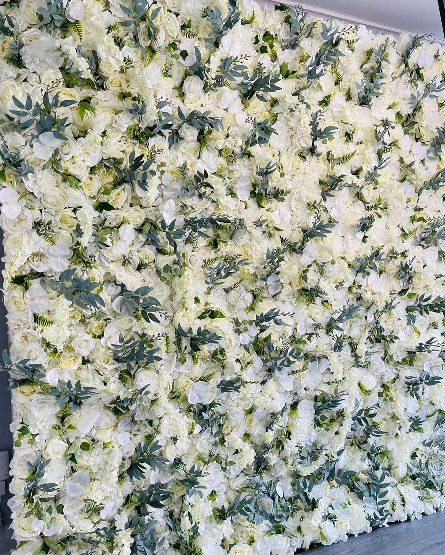 White Flower Wall with Greenery